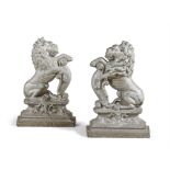 A PAIR OF 19TH CENTURY CAST IRON DOOR STOPS, painted in 'off white' and modelled as lions rampant