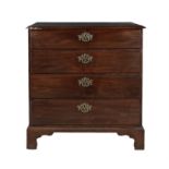 A GEORGE III MAHOGANY RECTANGULAR COMPACT CHEST, of four long drawers, on bracket feet.