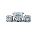A NEAR PAIR OF 19TH CENTURY JAPANESE EXPORT BLUE AND WHITE HEXAGONAL CRICKET JARS with reticulated
