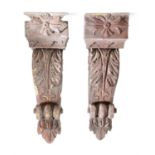 A PAIR OF NEO-CLASSICAL PAINTED PINE CORBELS, late 18th century, each headed with a rosette above