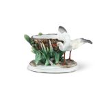 A VICTORIAN MAJOLICA TABLE CENTREPIECE, modelled as a stork building a nest. 28cm wide