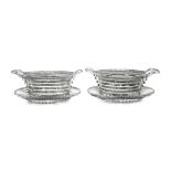 A FINE PAIR OF IRISH REGENCY CUTGLASS BUTTER COOLERS ON STANDS, each of oval form,