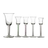 A MATCHED SUITE OF FIVE WINE GLASSES WITH AIR-TWIST STEMS, 18th Century and later.