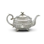 AN IRISH GEORGE IV OVAL TEAPOT, DUBLIN 1822, BY JAMES LE BAS of oblong shape embosses with berried