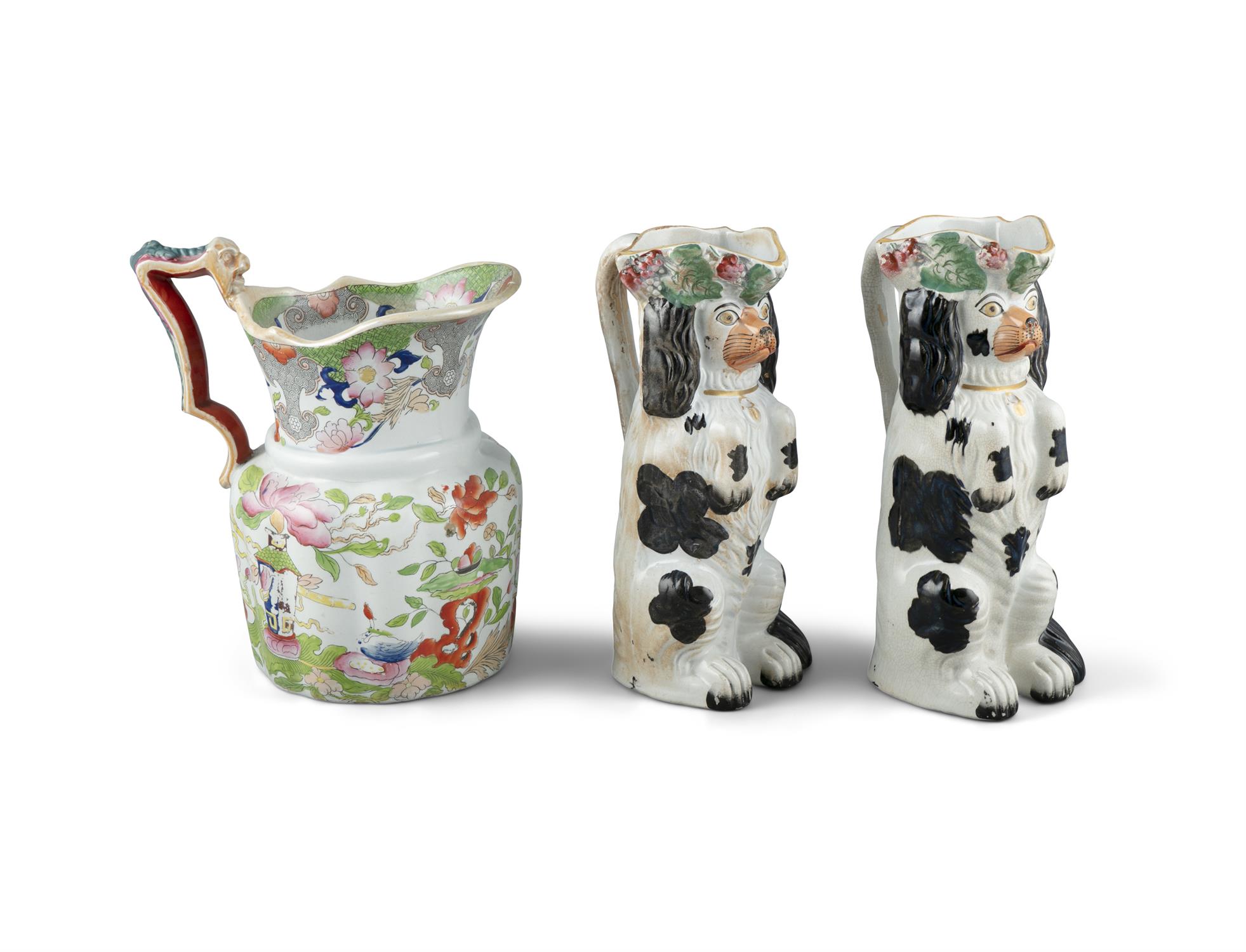 A PAIR OF 19TH CENTURY STAFFORDSHIRE JUGS, moulded in the form of spaniels. 26cm high; Together