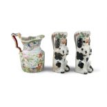 A PAIR OF 19TH CENTURY STAFFORDSHIRE JUGS, moulded in the form of spaniels. 26cm high; Together