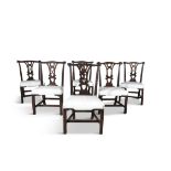 A SET OF SIX GEORGE III IRISH MAHOGANY FRAMED DINING CHAIRS, with carved crest rails above pierced