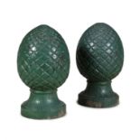 A PAIR OF CAST IRON PINEAPPLE GARDEN FINIALS, painted dark green. 49cm high