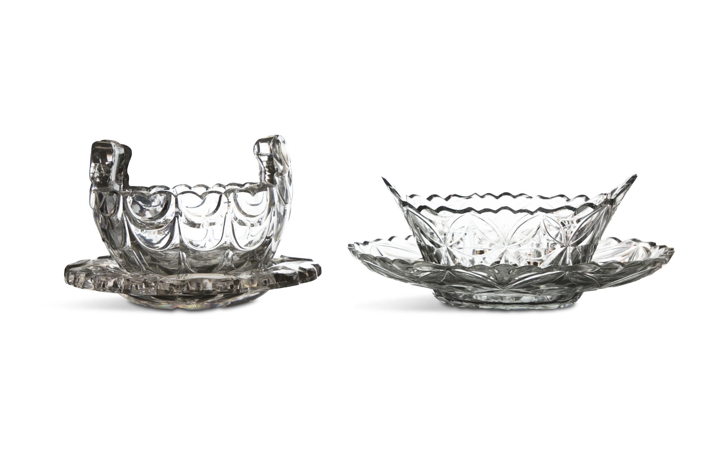 A CUT GLASS BUTTER BOAT ON STAND, of oval form, with raised fan shaped handles and flat cut