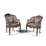 A PAIR OF FRENCH CARVED FRUITWOOD FRAMED BERGERE ARMCHAIRS, with cane backs and seats and loose