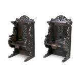 A PAIR OF CONTINENTAL CARVED OAK HALL SEATS, 19th century, in the 17th century style,