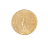 A MEXICAN GOLD 50 PESO COIN, the winged symbol of victory and the date 1821-1923, c.37.5g