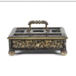 A FRENCH EBONISED AND CUT BRASS RECTANGULAR INK STAND, 19th century, with raised carrying handle