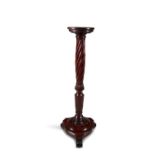 A VICTORIAN MAHOGANY TORCHERE STAND, with plain dished top, over a rope twist and fluted centre