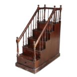 A 19TH CENTURY MAHOGANY LIBRARY STEPS, enclosed within spindle turned supports, the base with