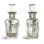 A PAIR OF 19TH CENTURY CLEAR GLASS SCENT BOTTLES AND STOPPERS, with figural cameo overlay depicting