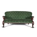 AN IRISH CARVED MAHOGANY AND UPHOLSTERED THREE SEAT SETTEE, with padded back seat and armrests,