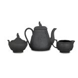 A WEDGWOOD BLACK BASALT WARE THREE- PIECE TEA SERVICE, comprising a teapot, cream jug,