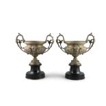 A PAIR OF VICTORIAN BRONZE AND BLACK MARBLE URNS, each with raised scroll side handles and circular