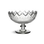 AN IRISH GEORGE III HEAVY CUTGLASS CENTRE BOWL, of circular form with wavy rim, cut with arches