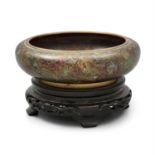 A CLOISONNE FLAT CIRCULAR BOWL, the mottled green ground decorated with floral sprays,
