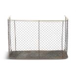 A VICTORIAN BRASS AND WIRE PANEL NURSERY FENDER, of bowed shaped design with trellis mesh panel and
