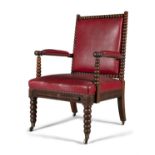 AN IRISH 19TH CENTURY BOBBIN TURNED WALNUT ARMCHAIR, in the manner of Strahan, upholstered in red