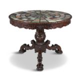 AN INLAID MARBLE TOP CIRCULAR CENTRE TABLE, the top radially set with specimen marbles on a green
