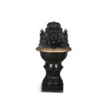 A VICTORIAN CAST IRON WATER FOUNTAIN, the domed backplate with lion mask, flanked with parcel gilt