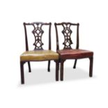 A PAIR OF GEORGE III MAHOGANY FRAMED DINING CHAIRS, in the Chippendale taste, with scroll carved