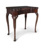 A GEORGE III IRISH MAHOGANY SERPENTINE SHAPED FOLDING TOP GAMES TABLE, opening to reveal a baise