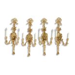 A SET OF FOUR GEORGIAN STYLE GILTWOOD TWO-LIGHT WALL SCONCES, surmounted with tied ribbons bedecked