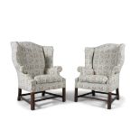 A PAIR OF IRISH MAHOGANY FRAMED UPHOLSTERED WING BACK ARMCHAIRS, with arched panel backs,