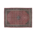 A LARGE PERSIAN MAHAL WOOL CARPET, c.1920, the red ground with small central medallion and