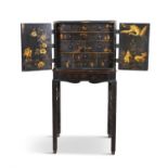 A GEORGE I BLACK AND GILT JAPANNED CHEST ON STAND, possibly Irish, c.1720, decorated with birds,