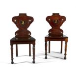A PAIR OF GEORGE IV MAHOGANY HALL CHAIRS, the shield panel backs decorated with painted crested