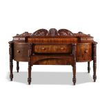 AN IRISH WILLIAM IV MAHOGANY BOW-FRONT SIDEBOARD, probably Cork, with scrolling acanthus carved
