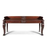 A FINE IRISH REGENCY CARVED MAHOGANY SERVING TABLE, of rectangular shape with three quarter gallery