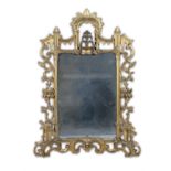 AN IRISH GEORGE III CARVED GILTWOOD MIRROR, c.1760, crested with a fountain, fitted with a
