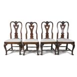 A SET OF FOUR GEORGE II PROVINCIAL OAK DINING CHAIRS, each with shell carved top rail,