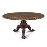 A VICTORIAN POLLARD OAK BREAKFAST TABLE, the figured top with carved wavy edge, on an acanthus