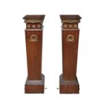 A PAIR OF BRASS MOUNTED MAHOGANY PLINTHS, of square tapering form, the top section with scroll