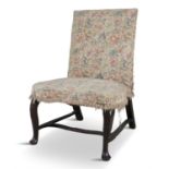 AN UNUSUAL WALNUT FRAMED IRISH PARLOUR CHAIR, c.1740, with raked back, the upholstered seat with