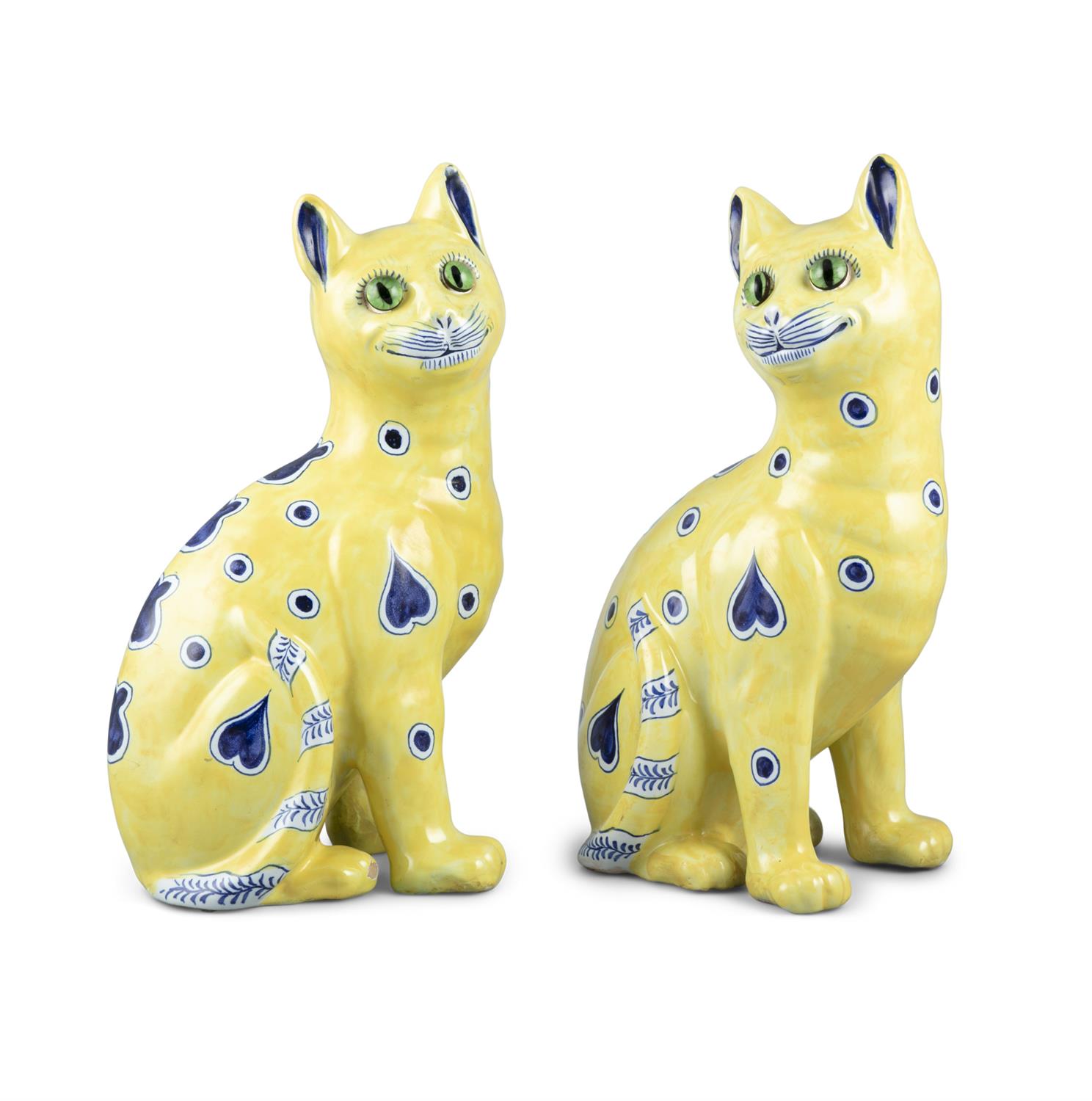 A PAIR OF GALLÉ FAIENCE WARE CATS, modelled in seat position, decorated with blue hearts and polka