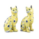 A PAIR OF GALLÉ FAIENCE WARE CATS, modelled in seat position, decorated with blue hearts and polka