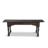AN EARLY 18TH CENTURY PROVINCIAL OAK LONG RECTANGULAR STOOL, raised on turned canted legs with