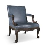 A GEORGE III MAHOGANY FRAMED LIBRARY ARMCHAIR, the rectangular padded back, foliate form armrests