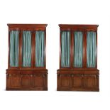 A PAIR OF VICTORIAN THREE DOOR MAHOGANY BOOKCASES, C.1850, the upper sections with glazed panel