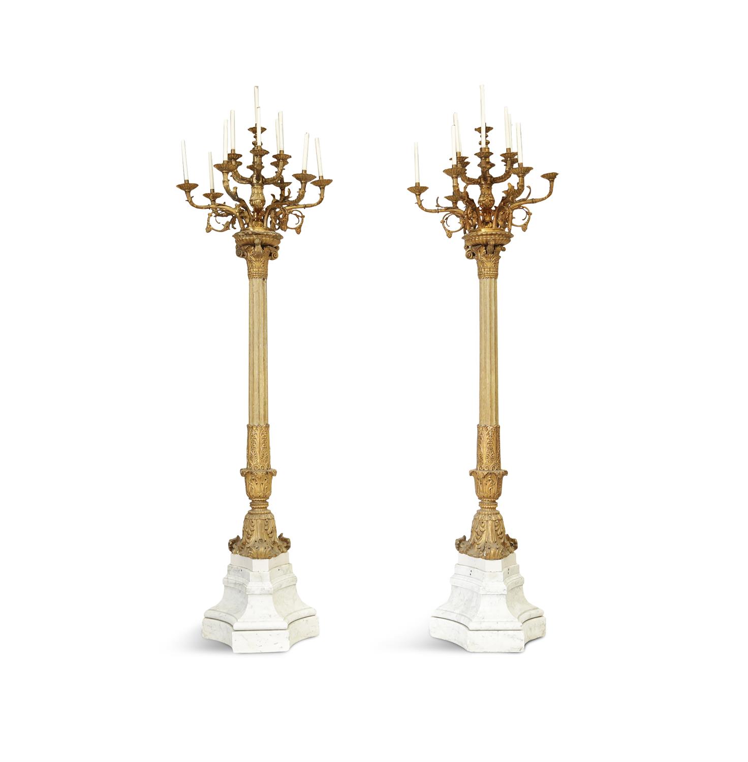 A PAIR OF 19TH CENTURY MONUMENTAL STANDING PALACE CANDELABRA, the gilt metal twelve light