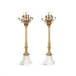 A PAIR OF 19TH CENTURY MONUMENTAL STANDING PALACE CANDELABRA, the gilt metal twelve light